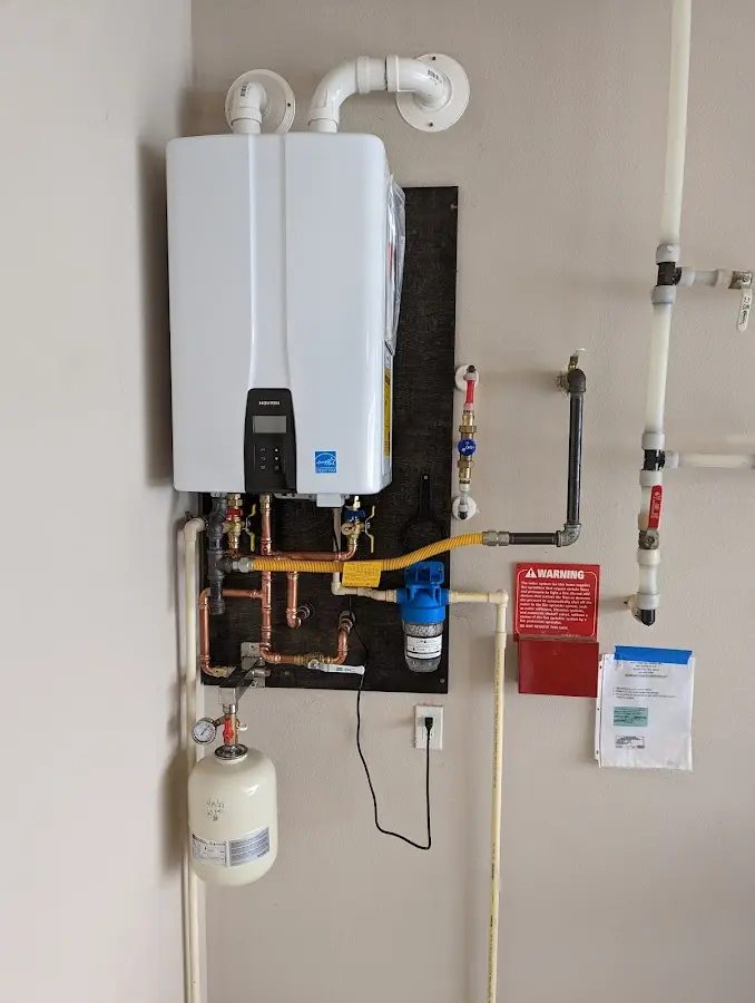 Professional plumber installing copper piping in a Lemoore home
